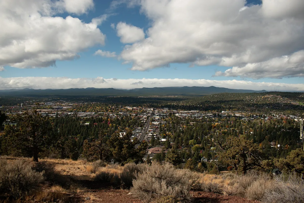 Homes and pine trees across Bend, Oregon seen from Pilot Butte, where many neighborhoods rely on condo association management