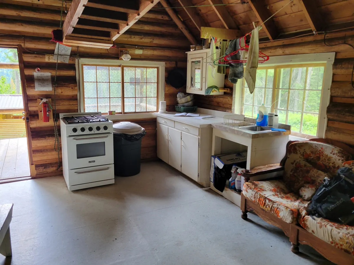 Log rental cabin kitchen and living area, the kind of space to list your Central Oregon rental with Thorn