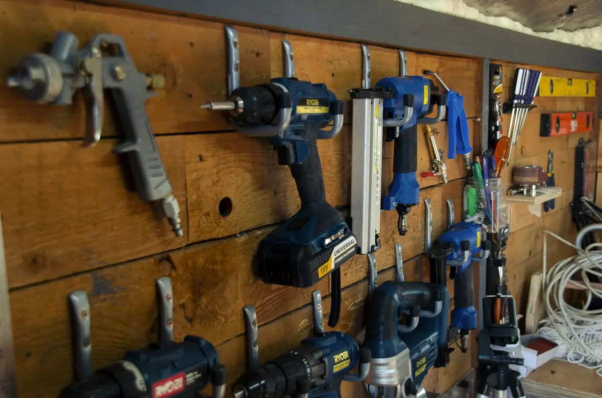 Power tools on a workshop wall, a reminder to check repair skills when you choose a property management company