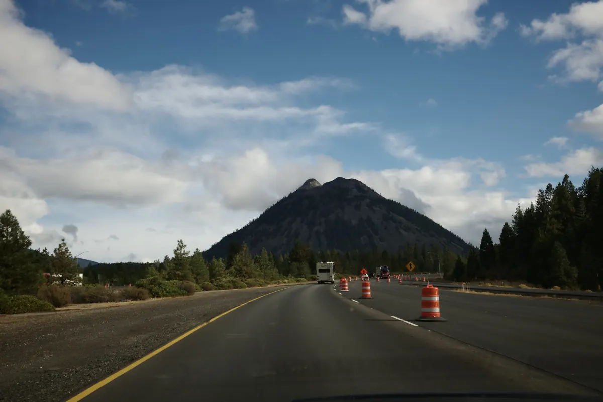 Black Butte cinder cone rising over a highway near Sisters, Oregon, in the Sisters Oregon property management area