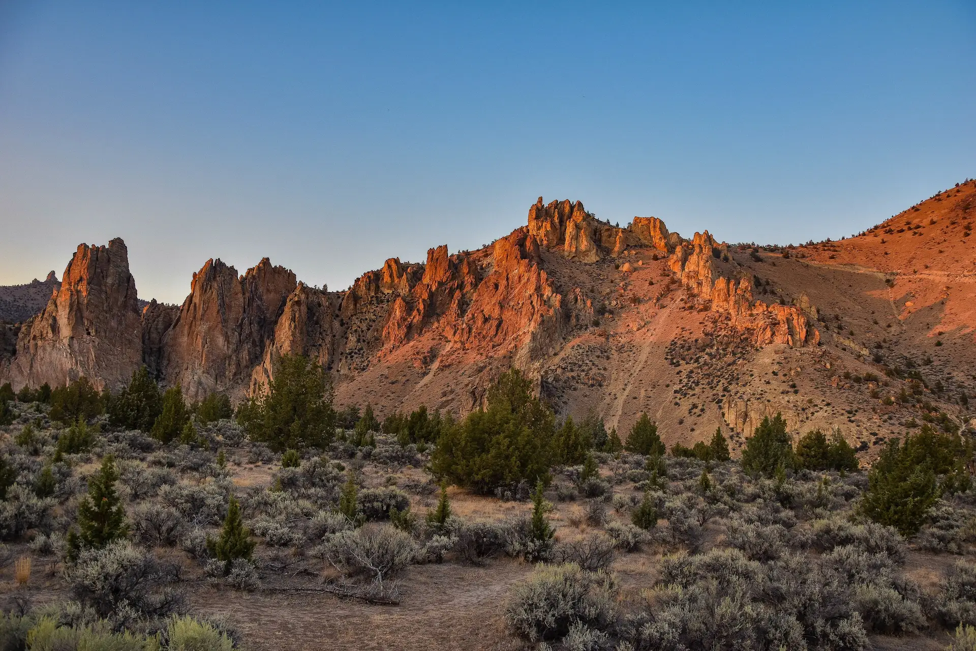 Smith Rock State Park cliffs glowing at sunset above high-desert sagebrush near Terrebonne, Central Oregon